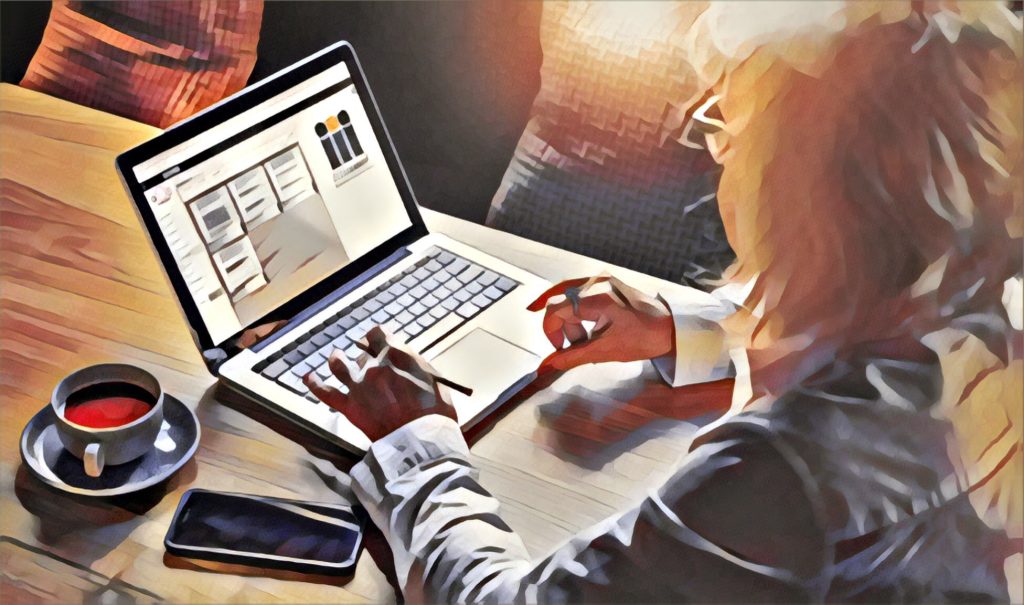 A professional leader working on a laptop with leadership development tools on the screen. A cup of coffee and a phone rest nearby, symbolising focus, strategy, and executive coaching in action.